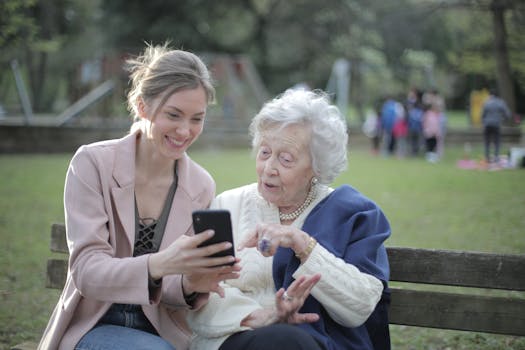 Lady showing her mom ElderGuarding on a phone while hanging out at the park.